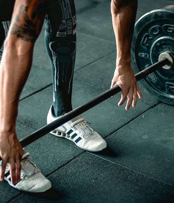Close-up of a person's hands gripping a barbell with determination.
